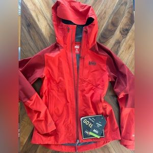 Women's REI Co-op Gort-Tex red rain jacket never worn. Size XS